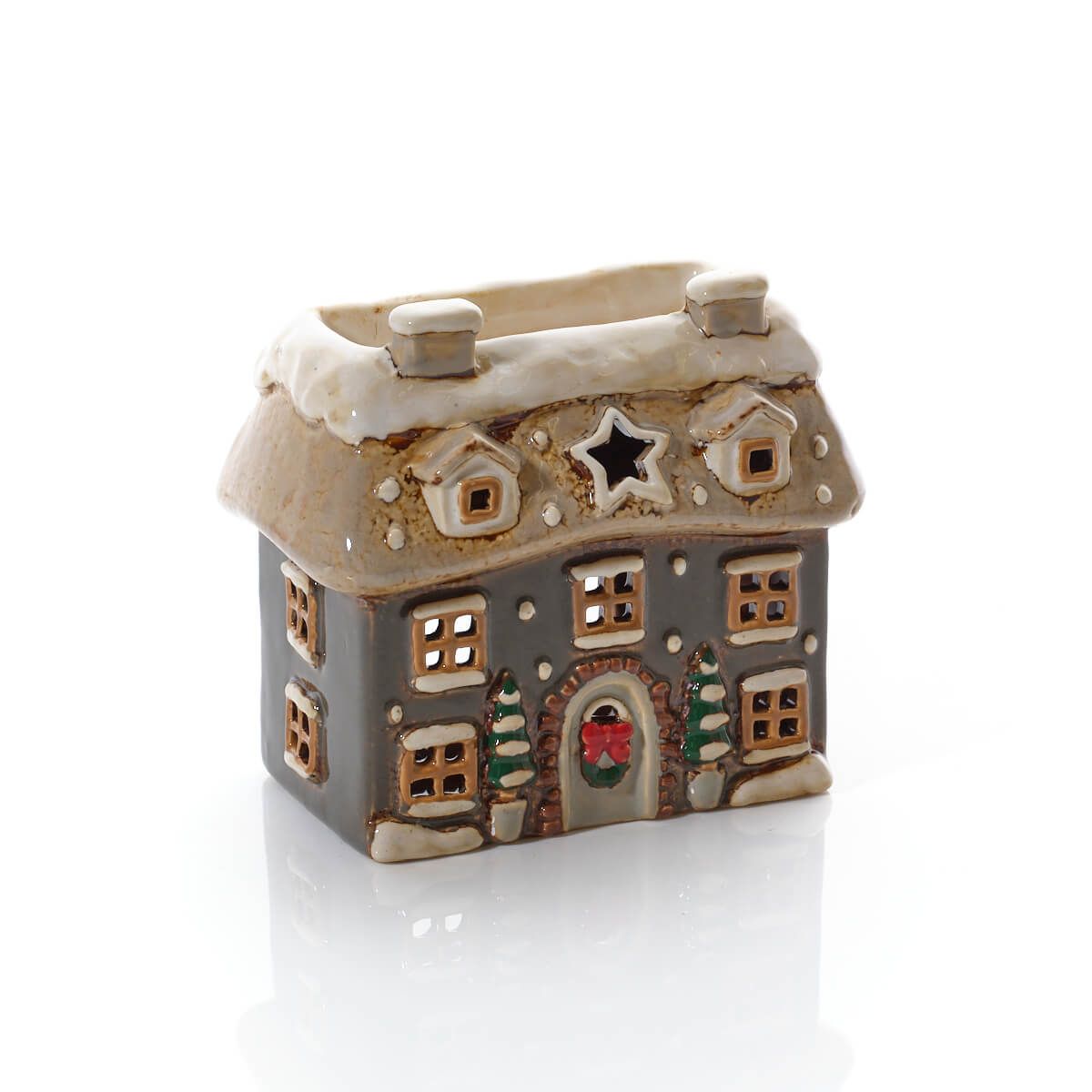 Christmas cottage wax melt burner in grey and cream stoneware with snow-topped roof, cut-out windows, little fir trees and a wreath on the door