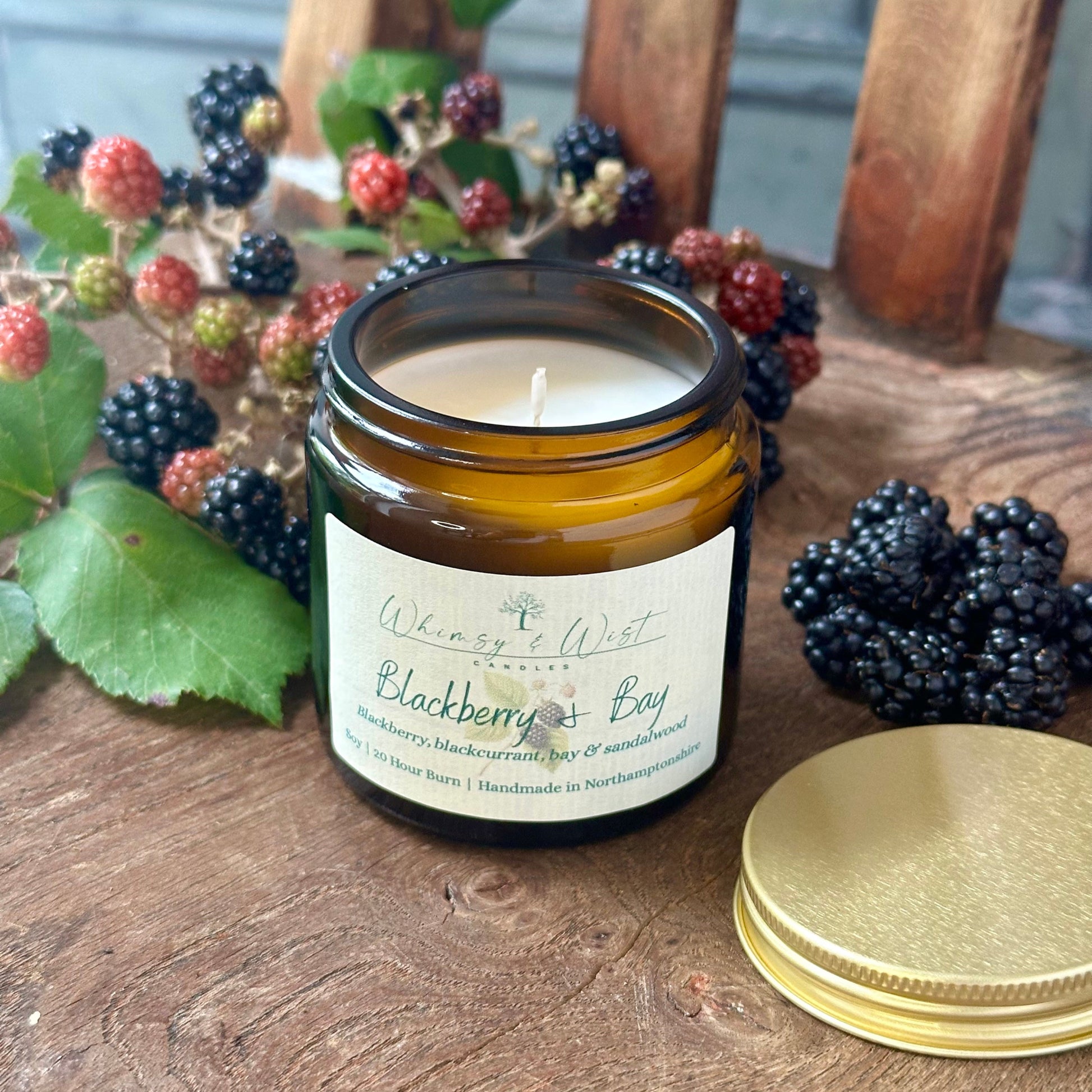 Blackberry & Bay soy candle in amber apothecary jar with gold lid, handmade in the UK.