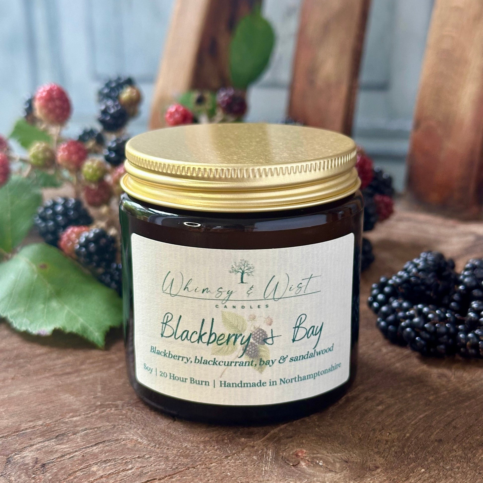 Blackberry & Bay soy candle in amber apothecary jar with gold lid, handmade in the UK.