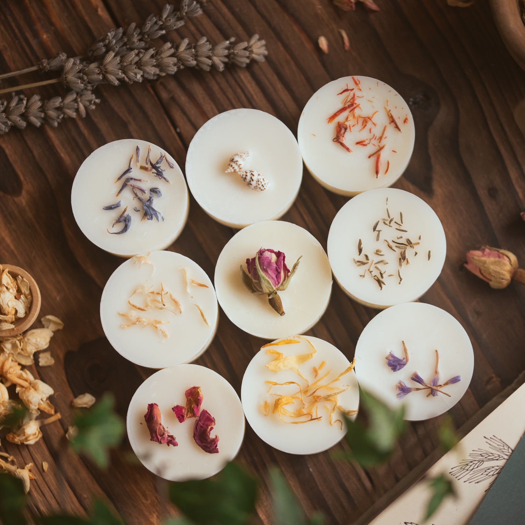 A selection of 9 wax melts, decorated with botanicals.