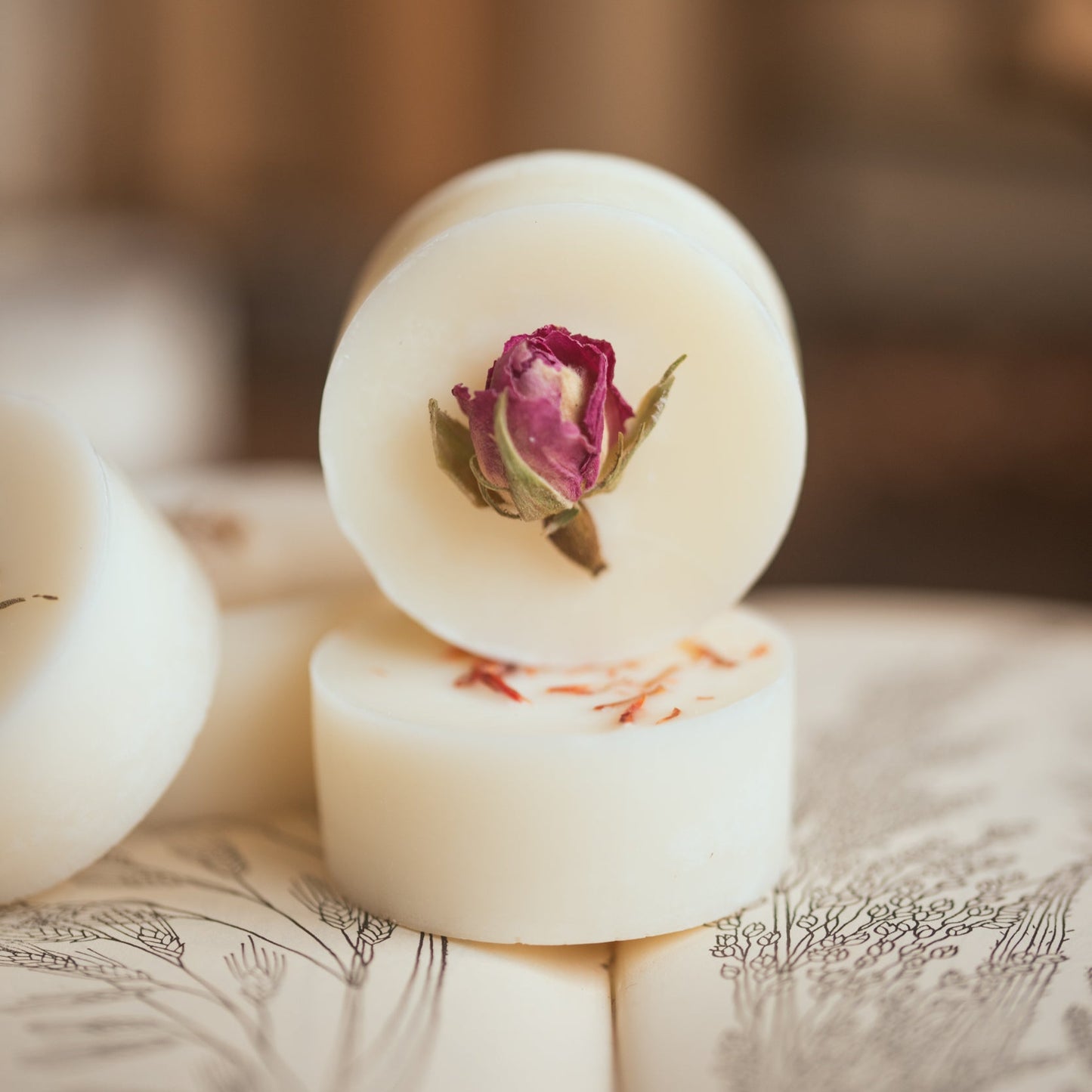 Wax melt, decorated with a rose bud.