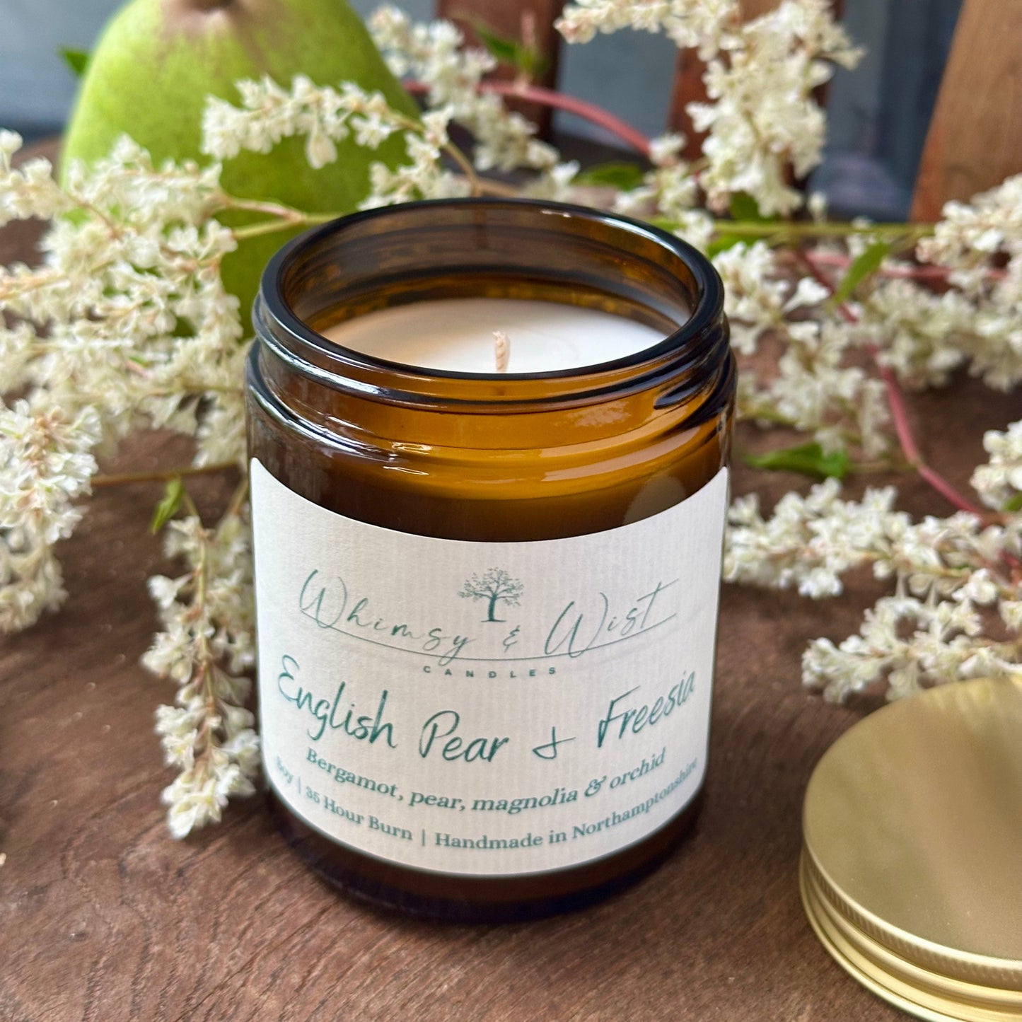 English Pear & Freesia soy candle in amber apothecary jar with gold lid, handmade in the UK.