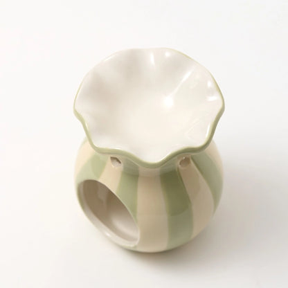 top view of pretty green and white wax melt burner with scalloped edge