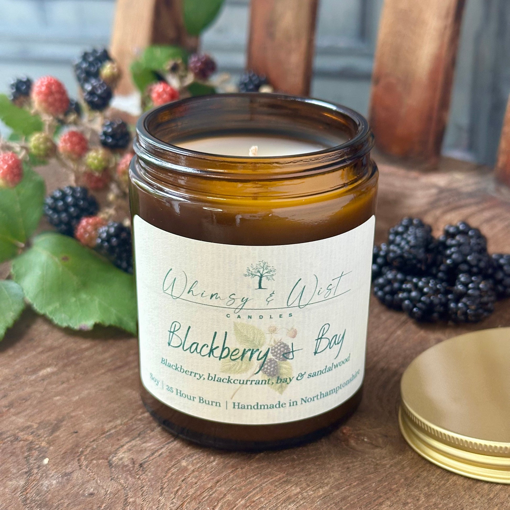Blackberry & Bay soy candle in amber apothecary jar with gold lid, handmade in the UK.