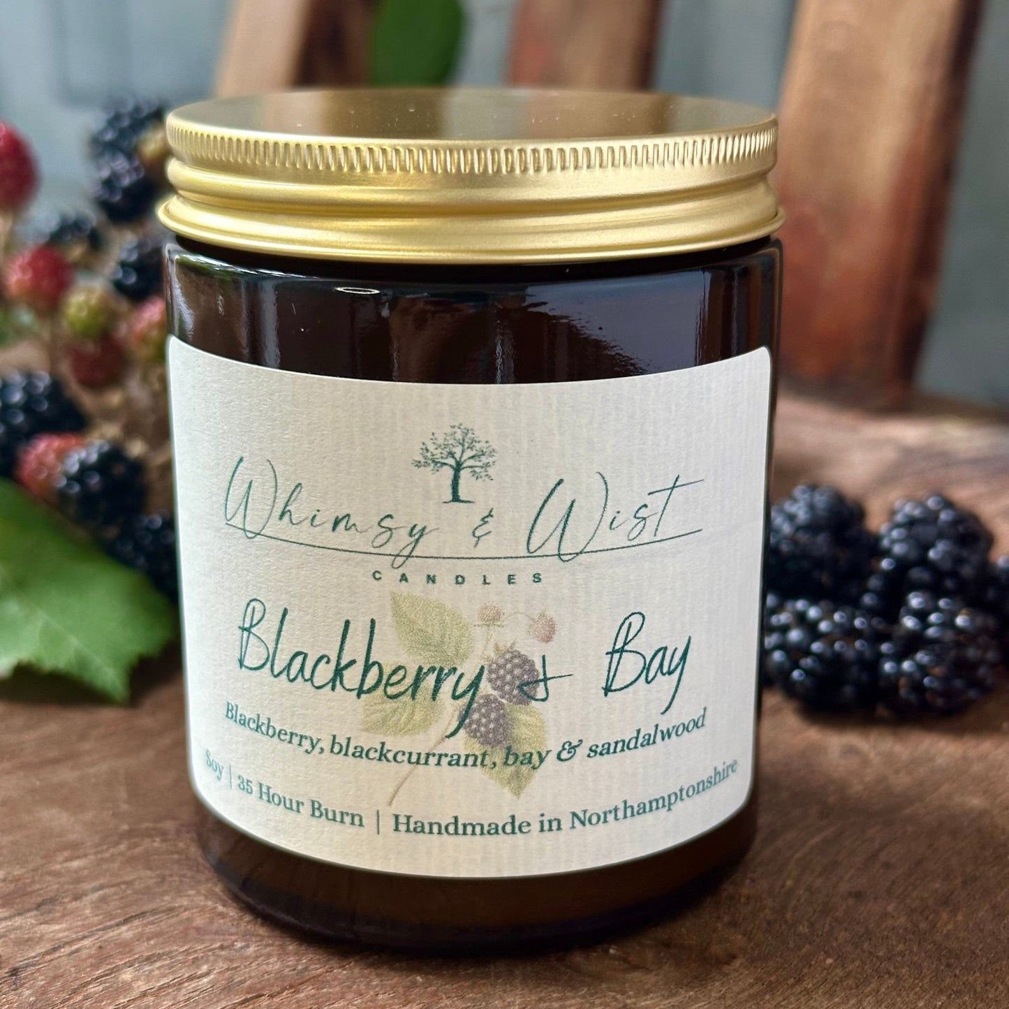 Blackberry & Bay soy candle in amber apothecary jar with gold lid, handmade in the UK.