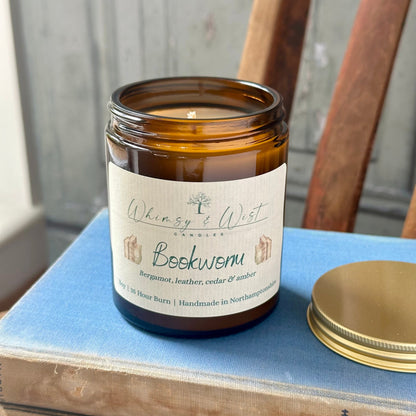 Bookworm soy candle in amber apothecary jar with gold lid, handmade in the UK.