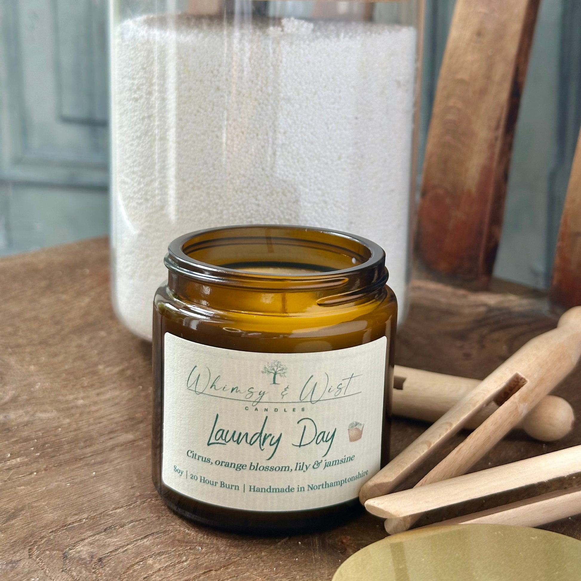 Laundry Day soy candle in amber apothecary jar with gold lid, handmade in the UK.