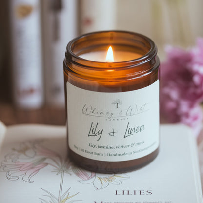 Clean floral soy candle with lily and musk in neutral spring home setting
