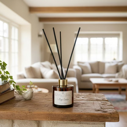 Reed diffuser with black reeds in a amber bottle on a wooden surface