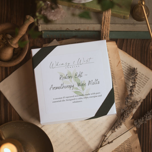 A box of wax melts on a rustic background.