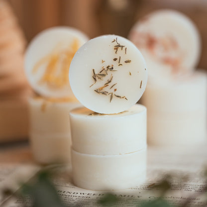 a selection of wax melts in different scents, piled up