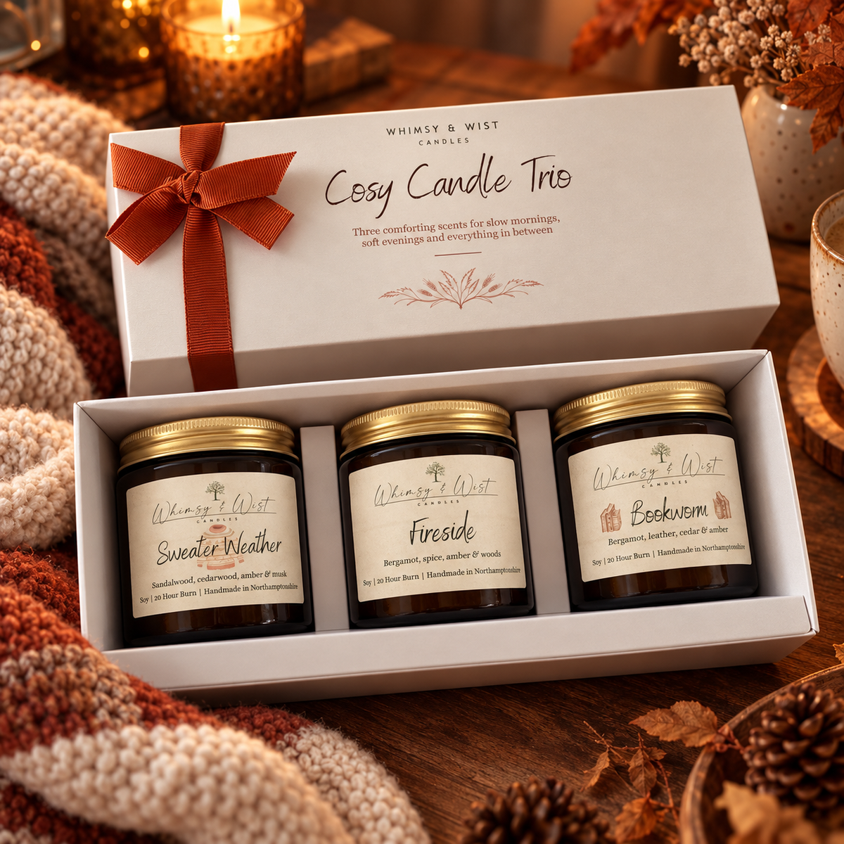 Open Cosy Candle Trio gift box with Sweater Weather, Fireside and Bookworm 120ml amber jar candles on a knitted blanket
