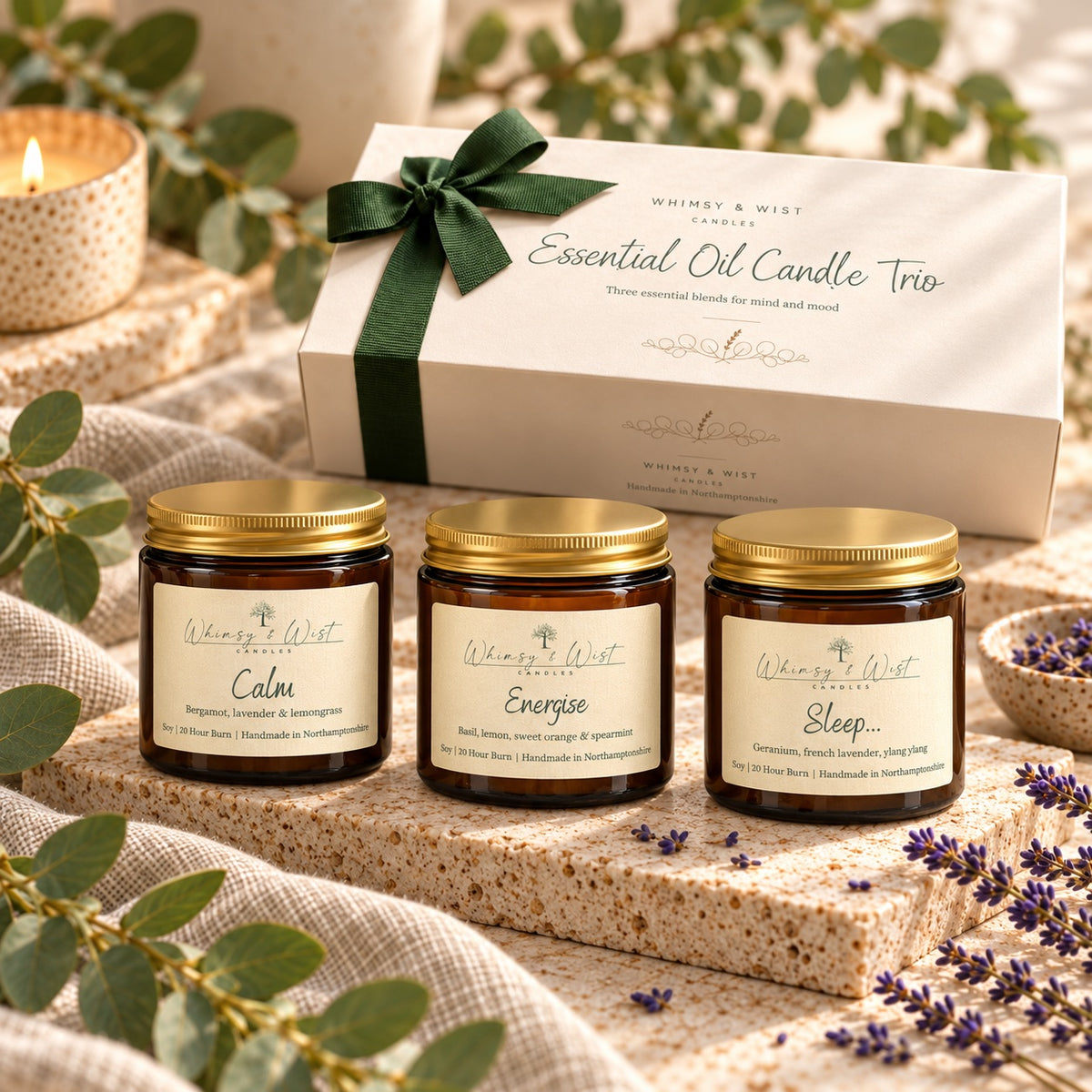 Calm, Energise and Sleep essential oil candles in 120ml amber jars beside the Essential Oil Candle Trio gift box