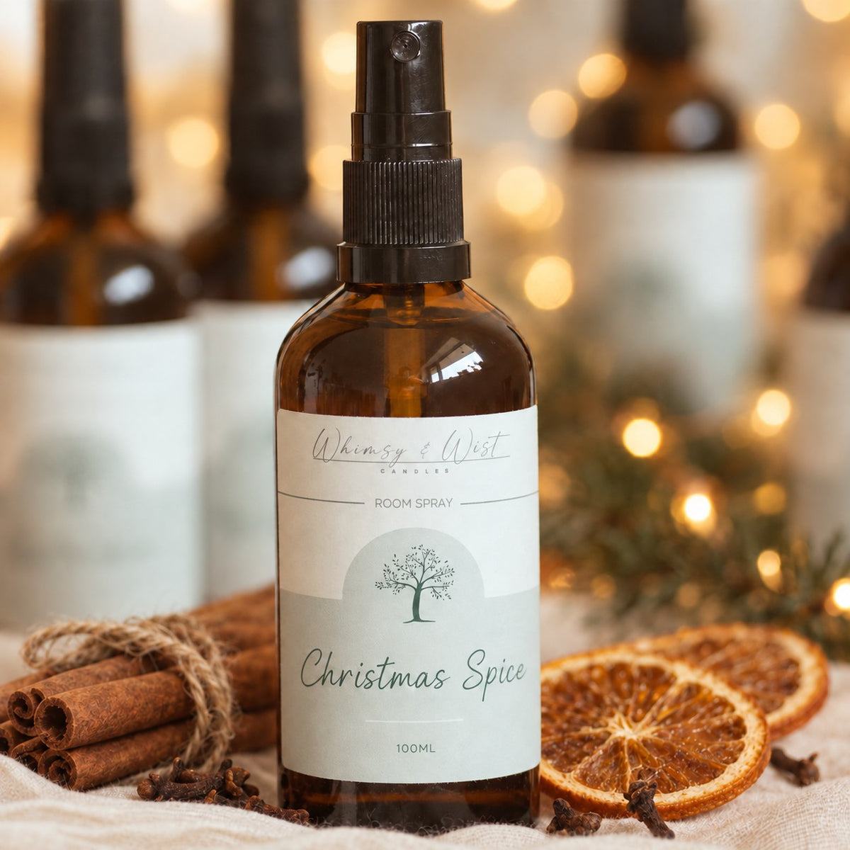 Whimsy & Wist Christmas Spice 100ml room spray in an amber glass bottle with cinnamon sticks, cloves and dried orange slices